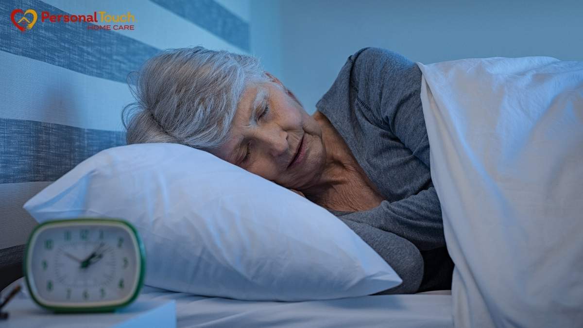 Elderly woman resting peacefully in bed at home under a warm blanket